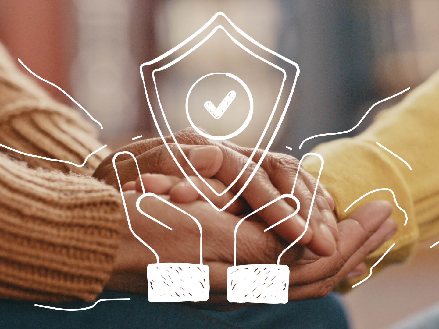 Picture of two people holding hands with a shield doodled on top