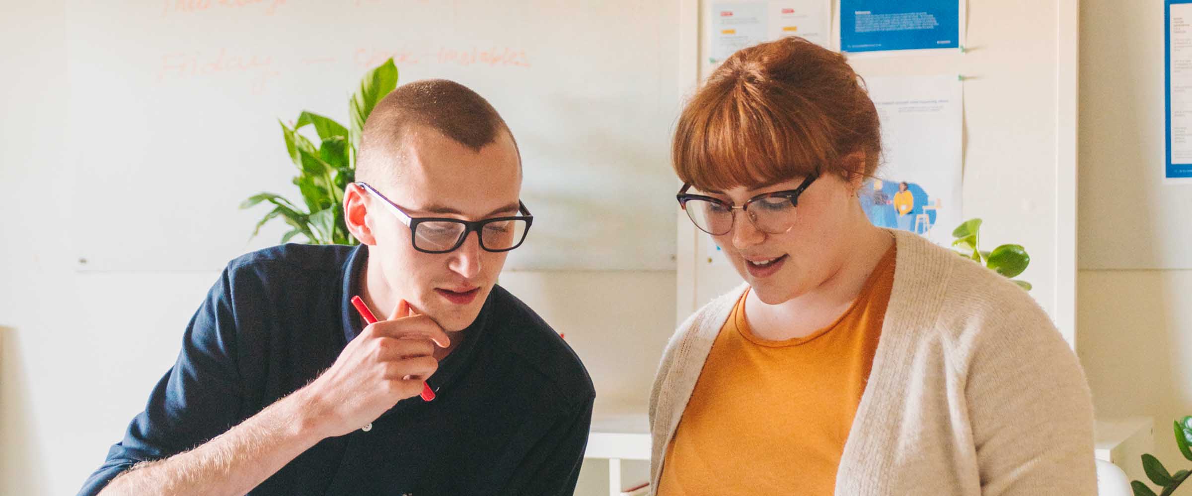 Two educators sitting at a table and working together