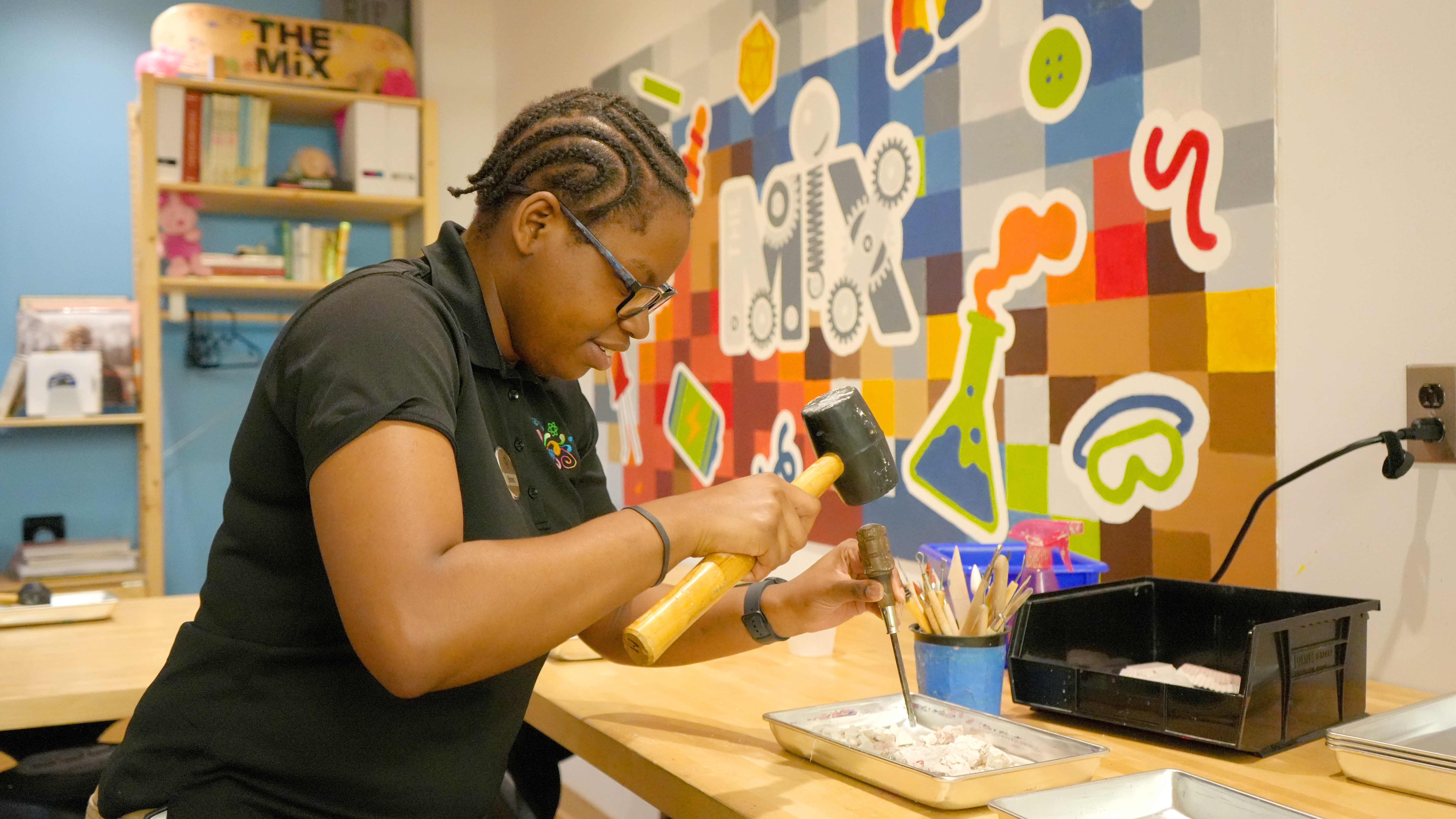 A girl working with concrete in a makerspace in Virginia