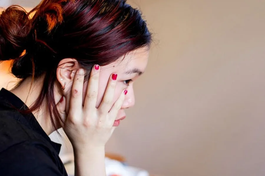 Side view of girl with hand on cheek