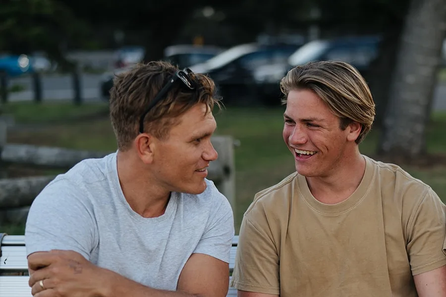 young guy talking to older guy