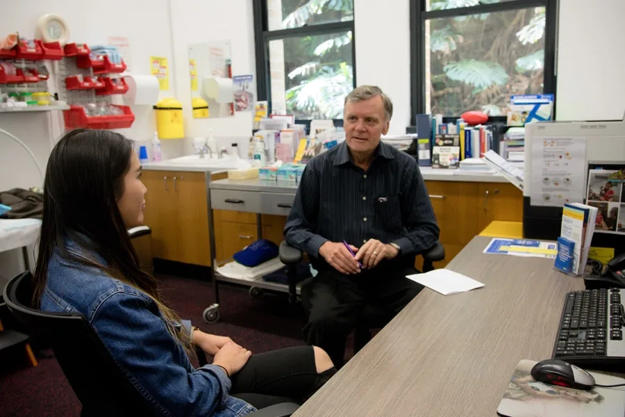 Girl in denim jacket talking to counsellor